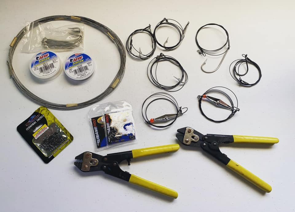 Wire leader, crimps and rigging tools laid out for a tackle orientation